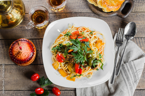 Konstfotografi Traditional asian uzbek noodle lagman with vegetables and meat on rustic wooden table background