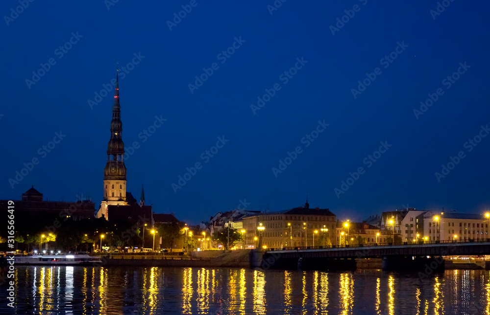 Riga, Latvia. View of the night city across the Daugava River..