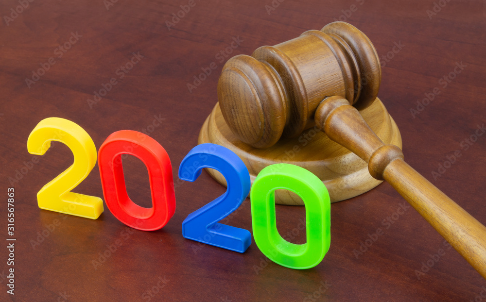 Wooden judge gavel and numbers 2020. Concept new laws in year 2020. Wooden judge gavel and numbers 2020. Concept new laws in year 2020.