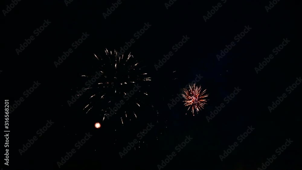Bright fiery flashes of sparkle festive fireworks in the night sky Bright fiery flashes of sparkle festive fireworks in the night sky