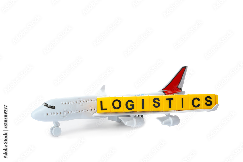 Toy plane and word LOGISTICS isolated on white. Wholesale concept