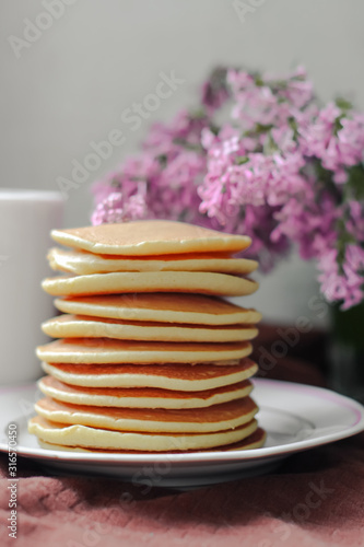  delicious pancakes on lilac background