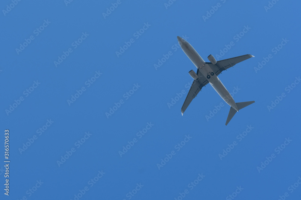 Bottom View of the Airplane in the sky with blank copy space for travel comcept Bottom View of the Airplane in the sky with blank copy space for travel comcept