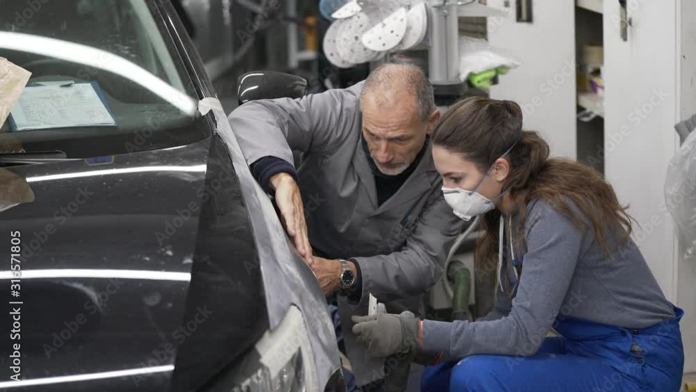 Apprentice with instructor working on vehicle Apprentice with instructor working on vehicle
