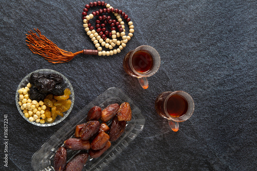  food Ramadan Sweets dried fruits and nuts Tea with a rosary and the on the table white,  Concept: month fasting culture Muslim and prayer for god, Ramadan food symbolic eastern Arabian