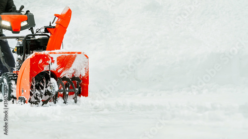 Snow removal on the street. Snow removal machine photo