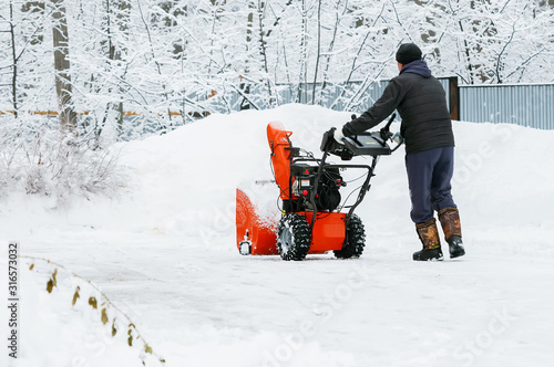 Snow removal on the street. Snow removal machine photo