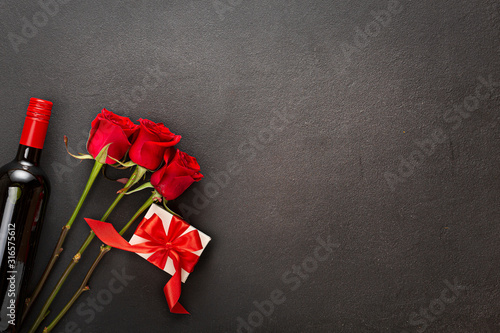 14.02. Wine, roses and gift box with a red bow. Love concept