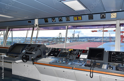 View of the control console on the navigational bridge of the cargo ship. Ship berthed in the port of Newark. 