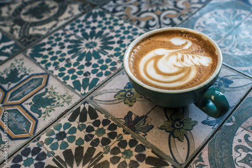 cup with capcino on colorful background