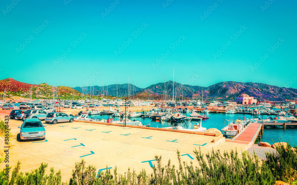 Old Sardinian Port and marina with ships at Mediterranean Sea in city of Villasimius in South Sardinia Island Italy in summer. Cityscape with Yachts and boats Old Sardinian Port and marina with ships at Mediterranean Sea in city of Villasimius in South Sardinia Island Italy in summer. Cityscape with Yachts and boats
