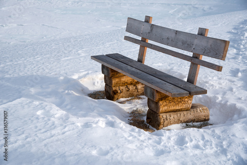 Wallpaper Mural Wooden bench next to a winter hiking trail in the austrian alps in Lungau, Salzburg, Austria. Torontodigital.ca