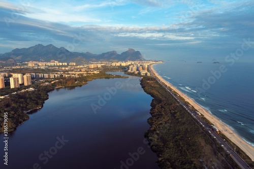 Aerial view of sunset on Barra da Tijuca's Beach, Rio de Janeiro city in the sunny day, Brazil. Great landscape. Vacation travel. Travel destination. Tropical travel. 