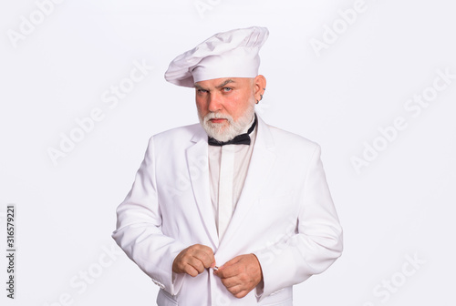 Old chef in uniform. Male cook in chef hat. Cook or baker man. Bearded man chef in uniform. Professional cook man. Diet. Healthy food. Portrait of old chef.