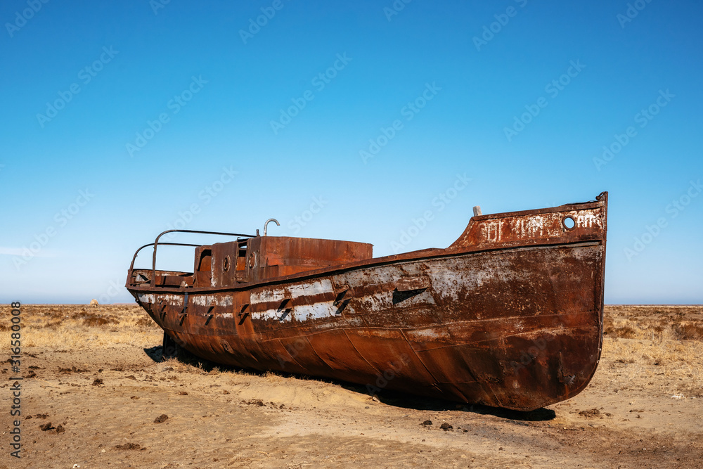 Abandoned boat in desert in Aral sea, Kazakhstan Abandoned boat in desert in Aral sea, Kazakhstan