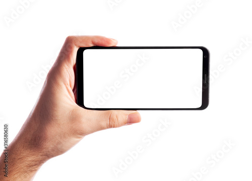 Man holding smartphone with empty screen isolated on white background. Male hand with phone, space for text