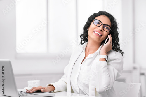 Happy hispanic girl talking on the phone
