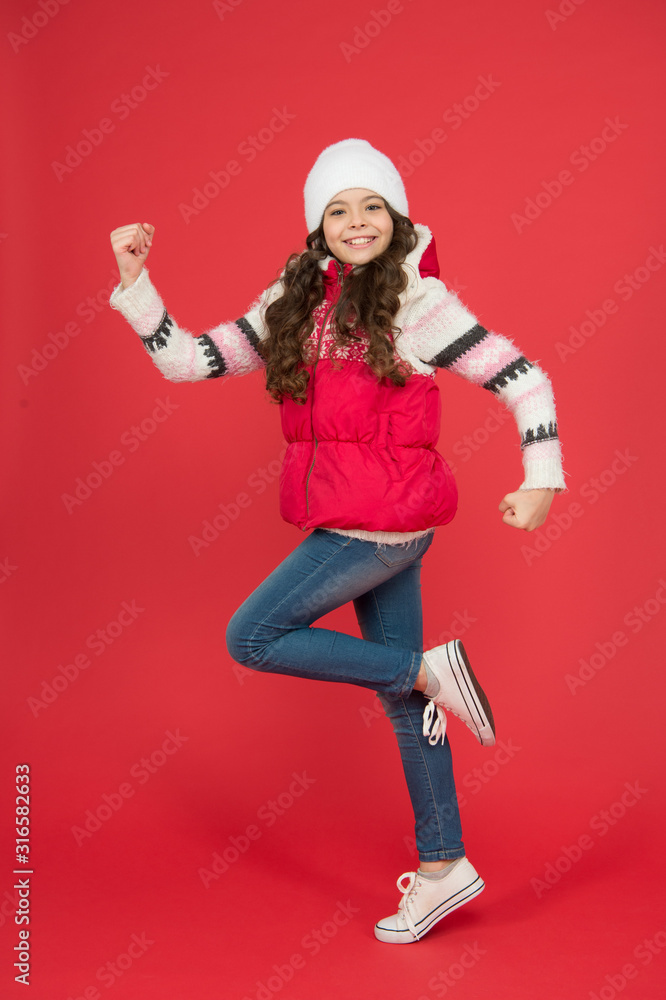 Active kid. Child in woolen knitted hat. Kids tend to feel cold more than adults. Winter fashion. Small girl long curly hair. Winter holidays ideas. Winter activity for kids. Happy childhood