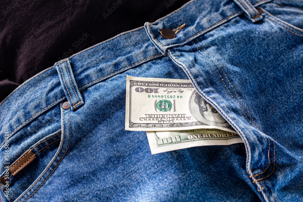 a two hundred dollar bills inside codpiece of blue jeans close-up with  selective focus Stock Photo | Adobe Stock