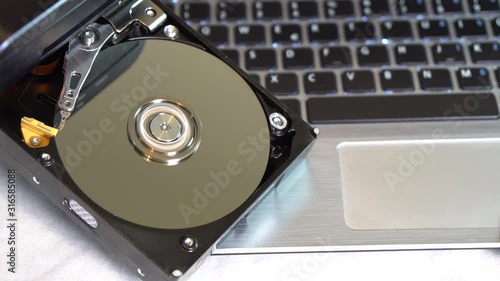 Technical laboratory for hard disk repair and data saving. Rotating disks of the Hard Disk with reflections.