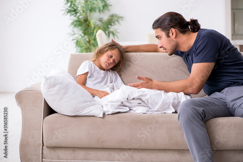 Father taking care of his ill daughter