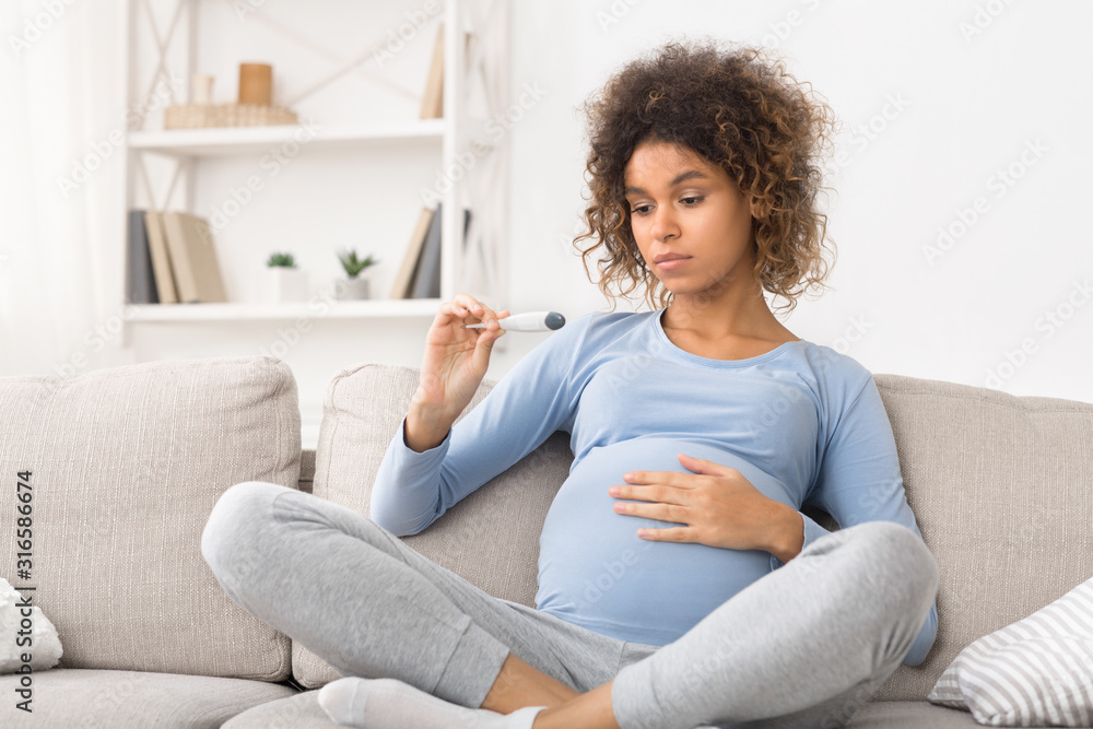 Sick expectant woman measuring temperature, having fever Sick expectant woman measuring temperature, having fever