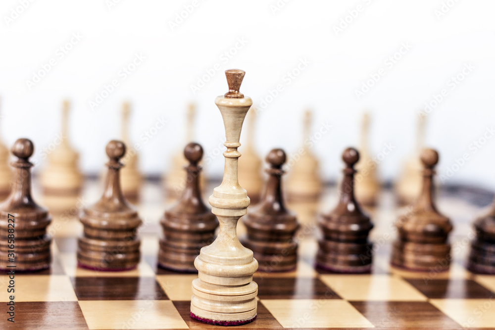 Reto black and white wooden chess pieces, queen in the foreground, leadership background. Reto black and white wooden chess pieces, queen in the foreground, leadership background.