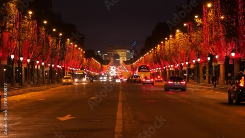 Beautiful evening in Paris, Champs Elysees decorated for Christmas, traffic near Arc de Triomphe