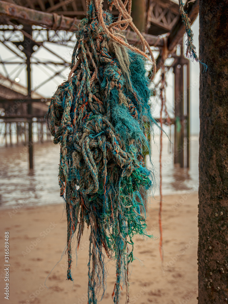 Fototapeta premium Mooring rope on the rusty iron construction of a pier