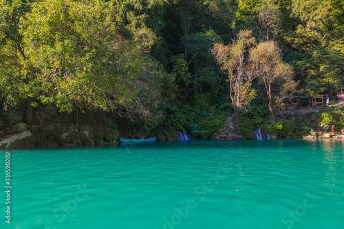 Amazing crystalline blue water of Tamul waterfall, Close up view of spectacular Tamul River,at Huasteca Potosina in San Luis Potosi, Mexico photo