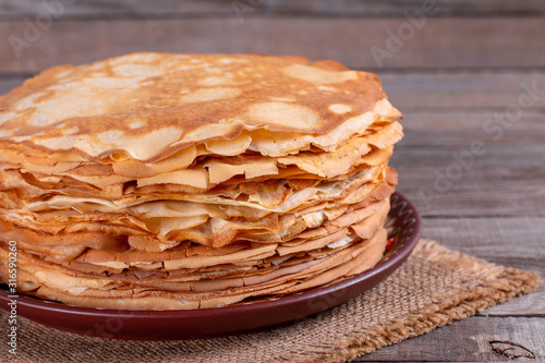 Stack of thin pancakes in a plate