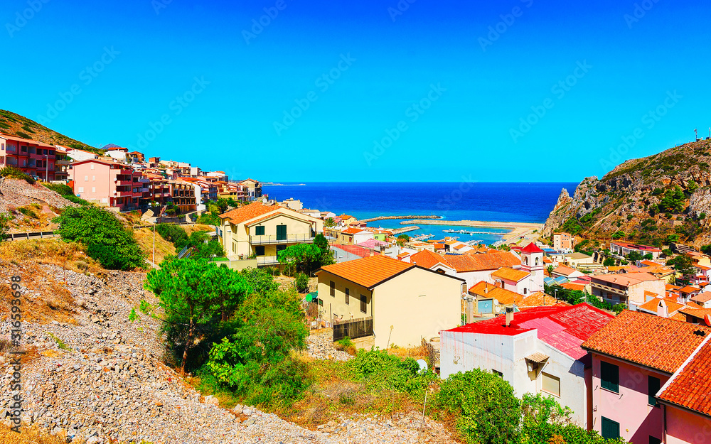 Cityscape with Buggerru city with cottage house architecture at the Mediterranean Sea in South Sardinia in Italy. Sardinian Italian small town in Sardegna.