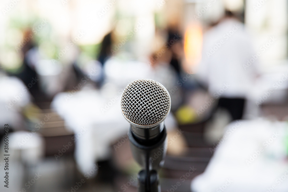 Microphone on blurred of speech in seminar room or speaking conference Microphone on blurred of speech in seminar room or speaking conference