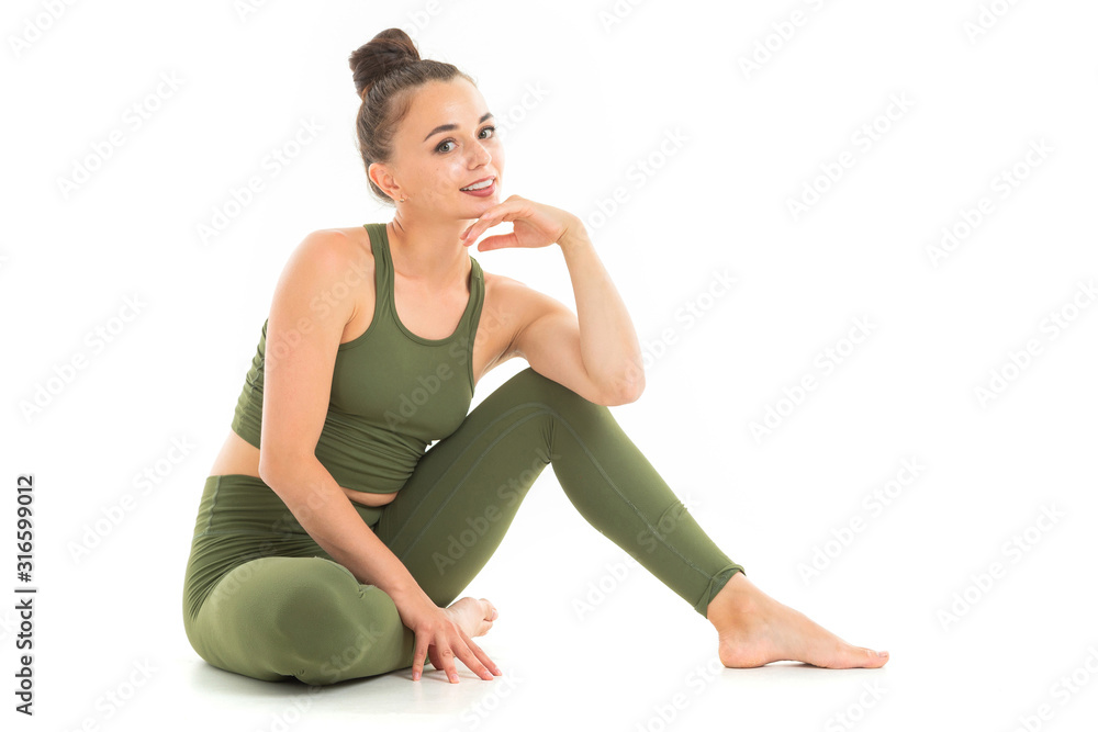 Fototapeta premium Caucasian gymnast with athletic body does warm-up and stretch muscles