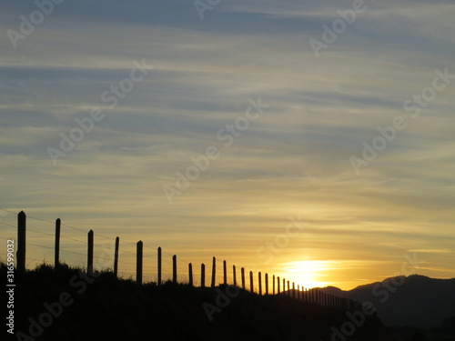late afternoon landscape in rural area and a wire fence