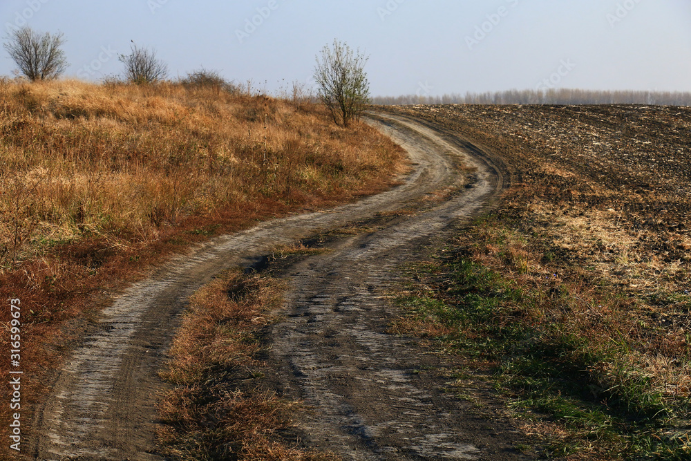 sunset over dirt road. Winter sunset over dirt road. Winter