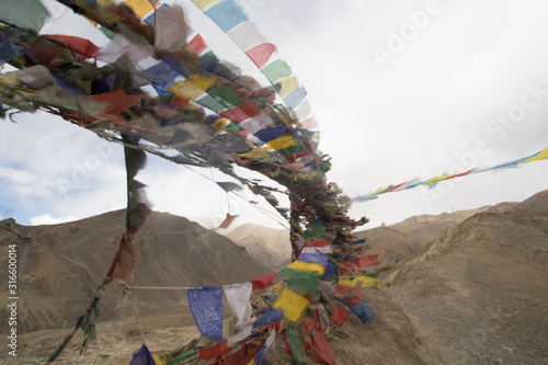 Tibetan flags waving on the wind in Ladakh, India photo