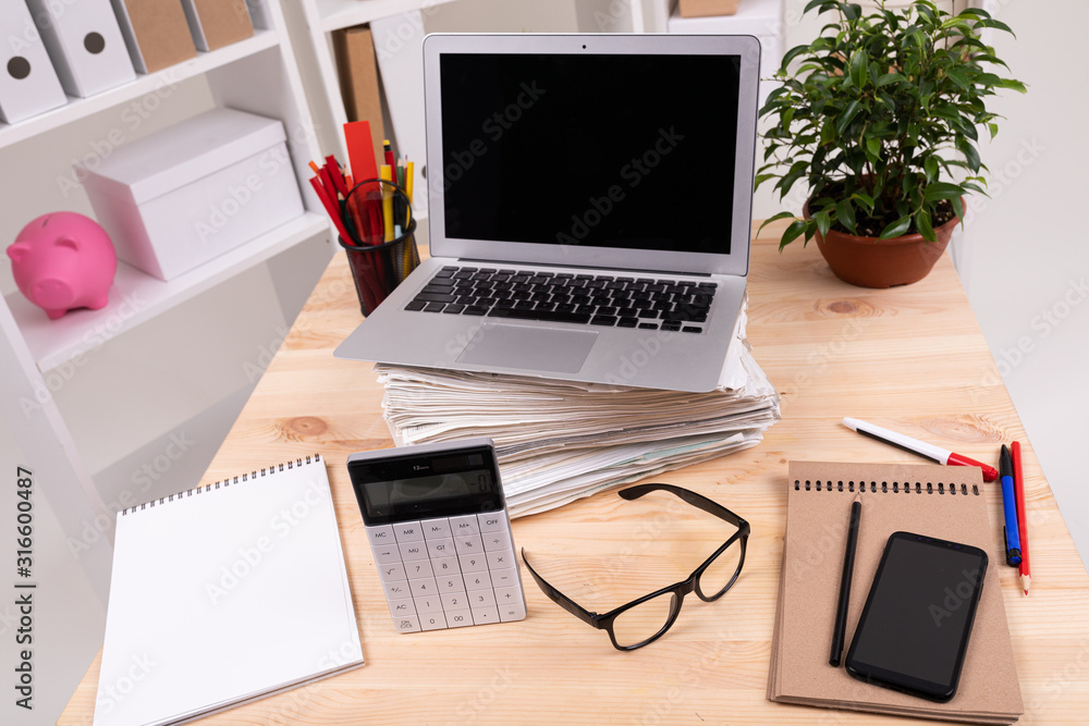 esktop with laptop, glasses, calculator, pens, pencils, card, phone and a plant in the office esktop with laptop, glasses, calculator, pens, pencils, card, phone and a plant in the office