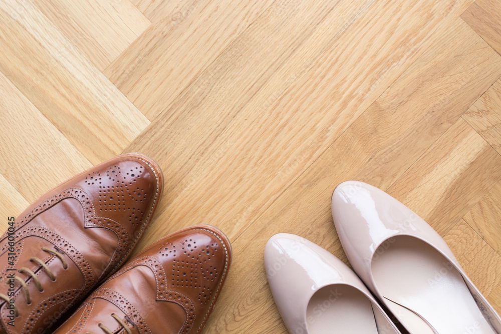 stylish leather shoes of a man and of a woman on wooden floor stylish leather shoes of a man and of a woman on wooden floor