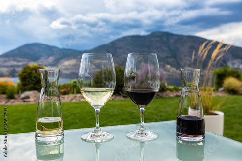 mini decanters and wine glasses filled with red and white wines selective focus, Canadian Okanagan Lake, Valley region, British Columbia BC Canada