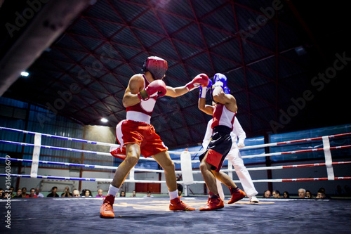 Two boxers fighting in a ring © Nuaestudio