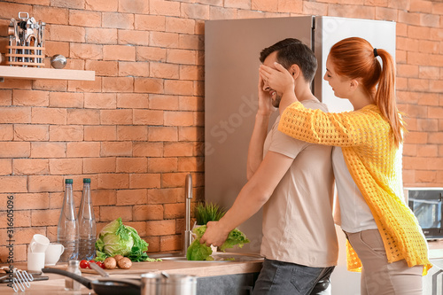 Woman Surprising Man Washin...