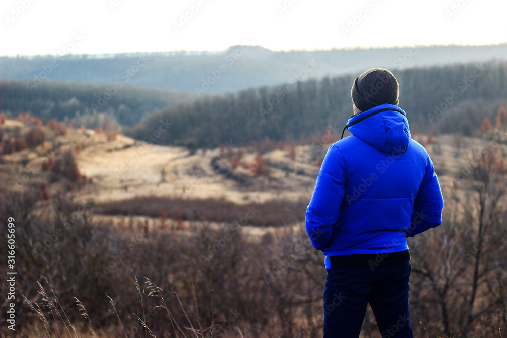 guy alone looks into the distance in the steppe guy alone looks into the distance in the steppe