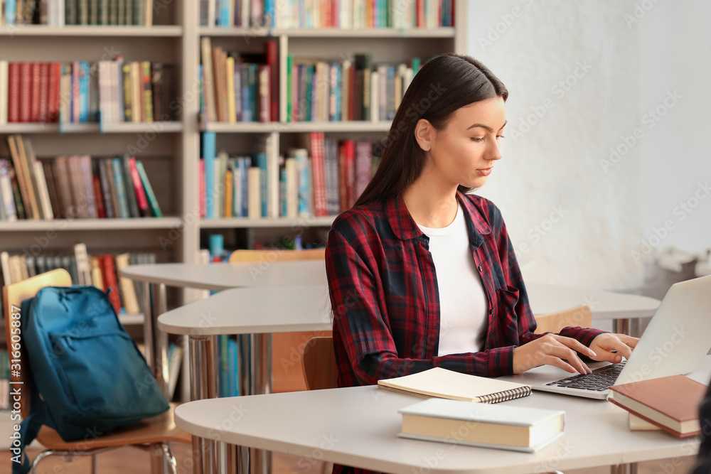 Female student preparing for exam in library Female student preparing for exam in library