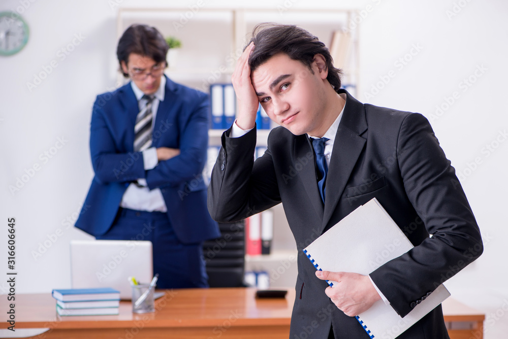 Boss and his male assistant working in the office