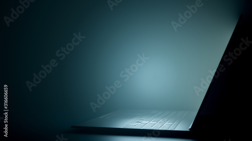 Digital Dark Workspace with a Modern Black Laptop. Realistic Laptop Side View with Copy Space. 3D Render.