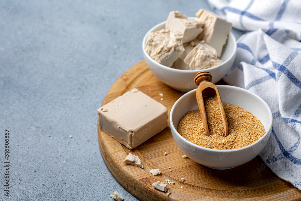 Dry and pressed yeast in ceramic bowls. Dry and pressed yeast in ceramic bowls.
