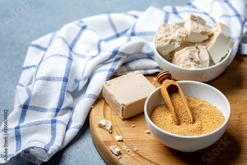 Different types of yeast in ceramic bowls. photo