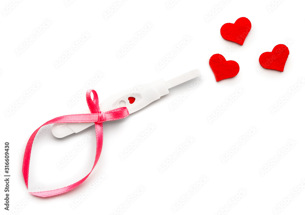 Pregnancy test and hearts on white background Pregnancy test and hearts on white background