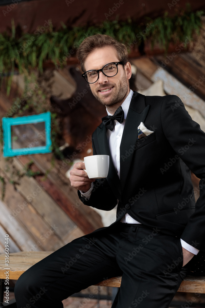 Confident fashion model holding a coffee cup Confident fashion model holding a coffee cup